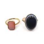 Two Victorian agate and yellow metal (tested as gold) and gold rings. One 18ct yellow gold inset