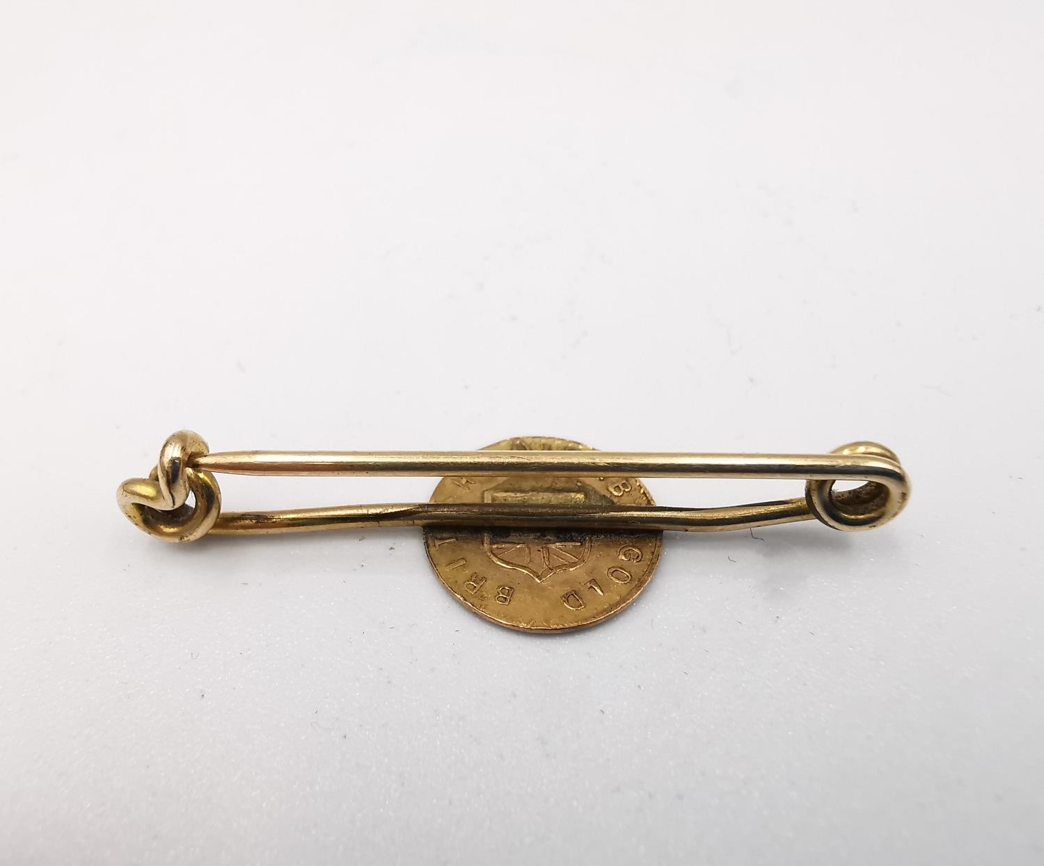 A 1912 British Columbia 9 carat gold dollar token on a yellow metal (tests as 9ct) pin. Weight 1g. - Image 2 of 5