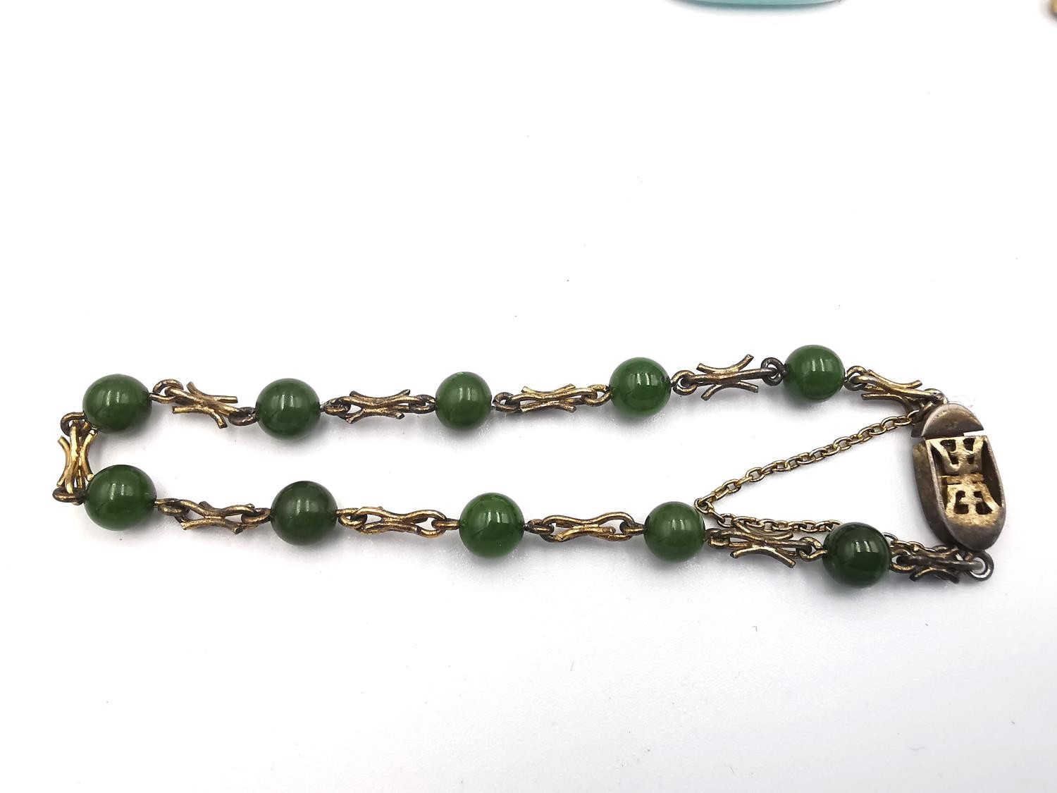 A collection of jewellery, including a Chinese silver gilt jade bead bracelet, a silver squiggle - Image 3 of 8