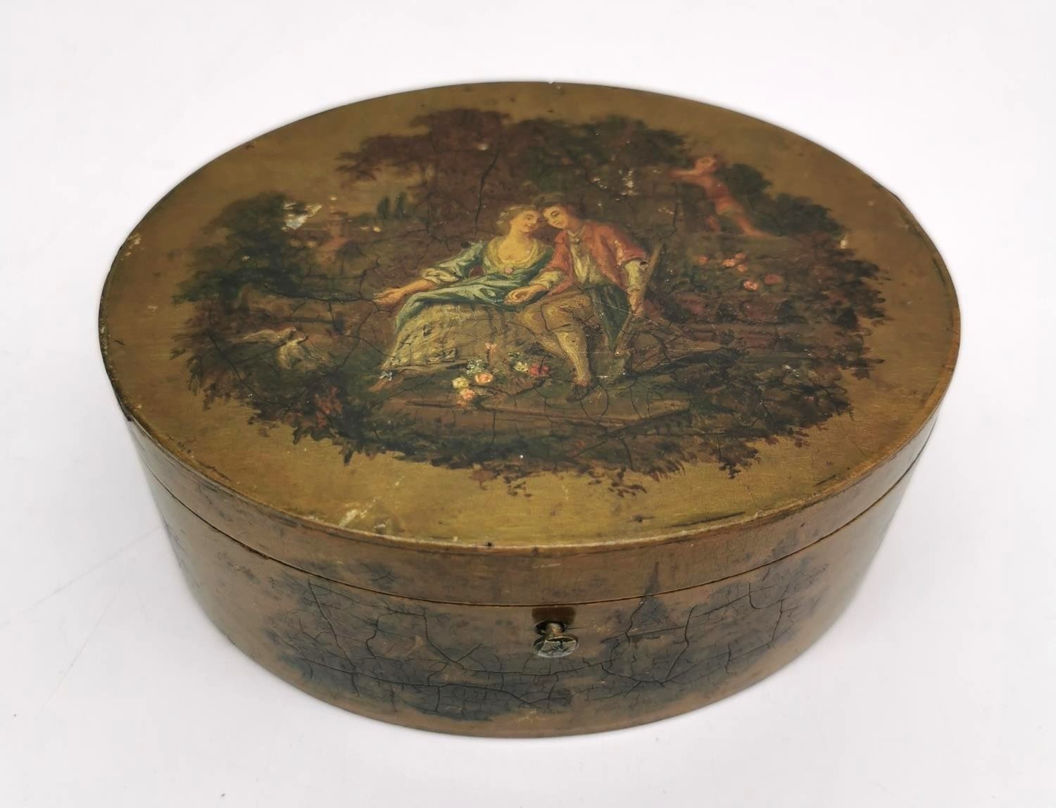 A 19th Century oval hand painted papier mache jewellery box, The top painted with a pair of lovers