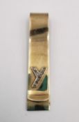 A yellow metal (tests as 9ct) yellow gold and diamond money clip. The clip adorned with the letter Y