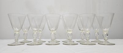 A set of twelve hand blown Murano glass wine glasses with hollow stems. H.15.5cm.