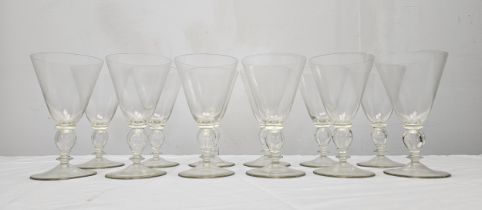 A set of twelve hand blown Murano glass wine glasses with hollow stems. H.15.5cm.