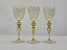 A set of three hand blown Avventurina Venetian Murano glass wine glasses with linear design. H.22.