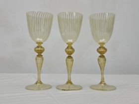 A set of three hand blown Avventurina Venetian Murano glass wine glasses with linear design. H.22.