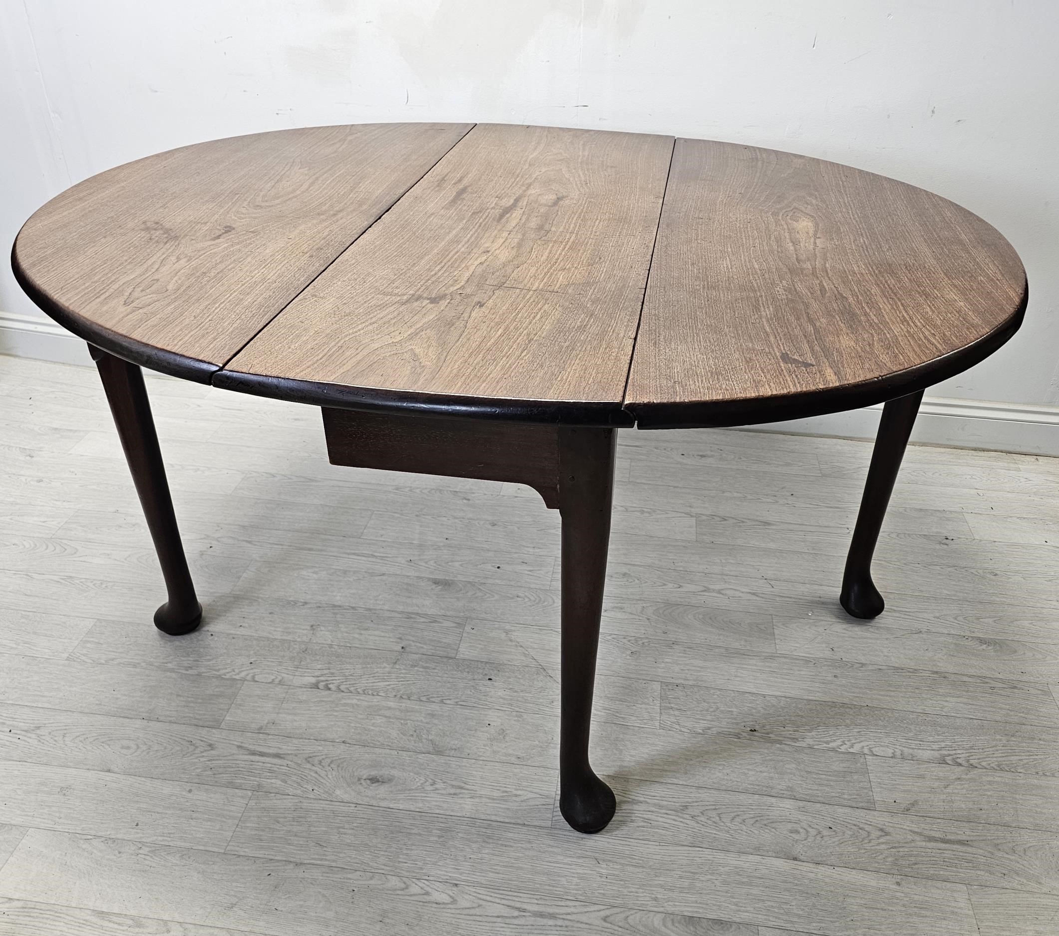 Dining table, Georgian red walnut with drop leaf gateleg action. H.76 W.132 D.116cm.