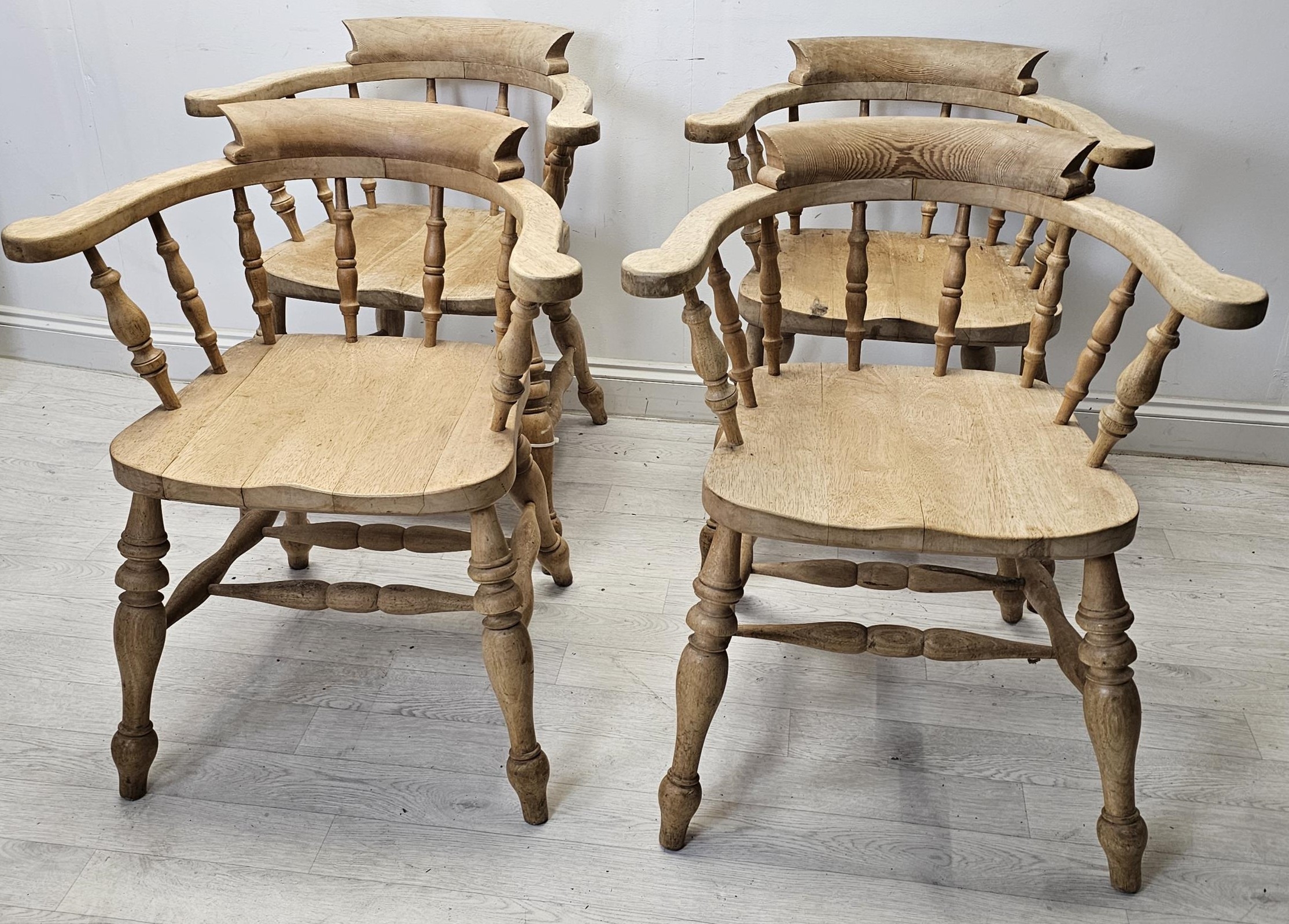 Bow back armchairs, a set of four C.1900 with saddle seats on turned stretchered supports. H.80 W.68