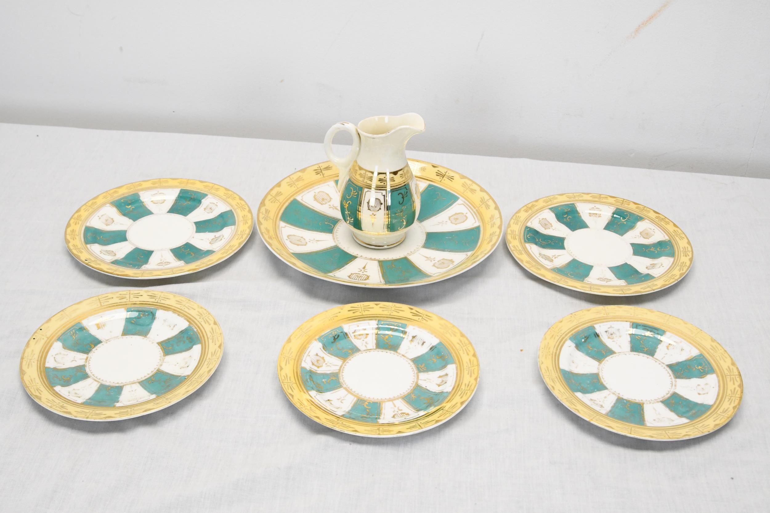 A hand painted 19th century green white and gold sunray pattern incomplete tea set. Largest plate