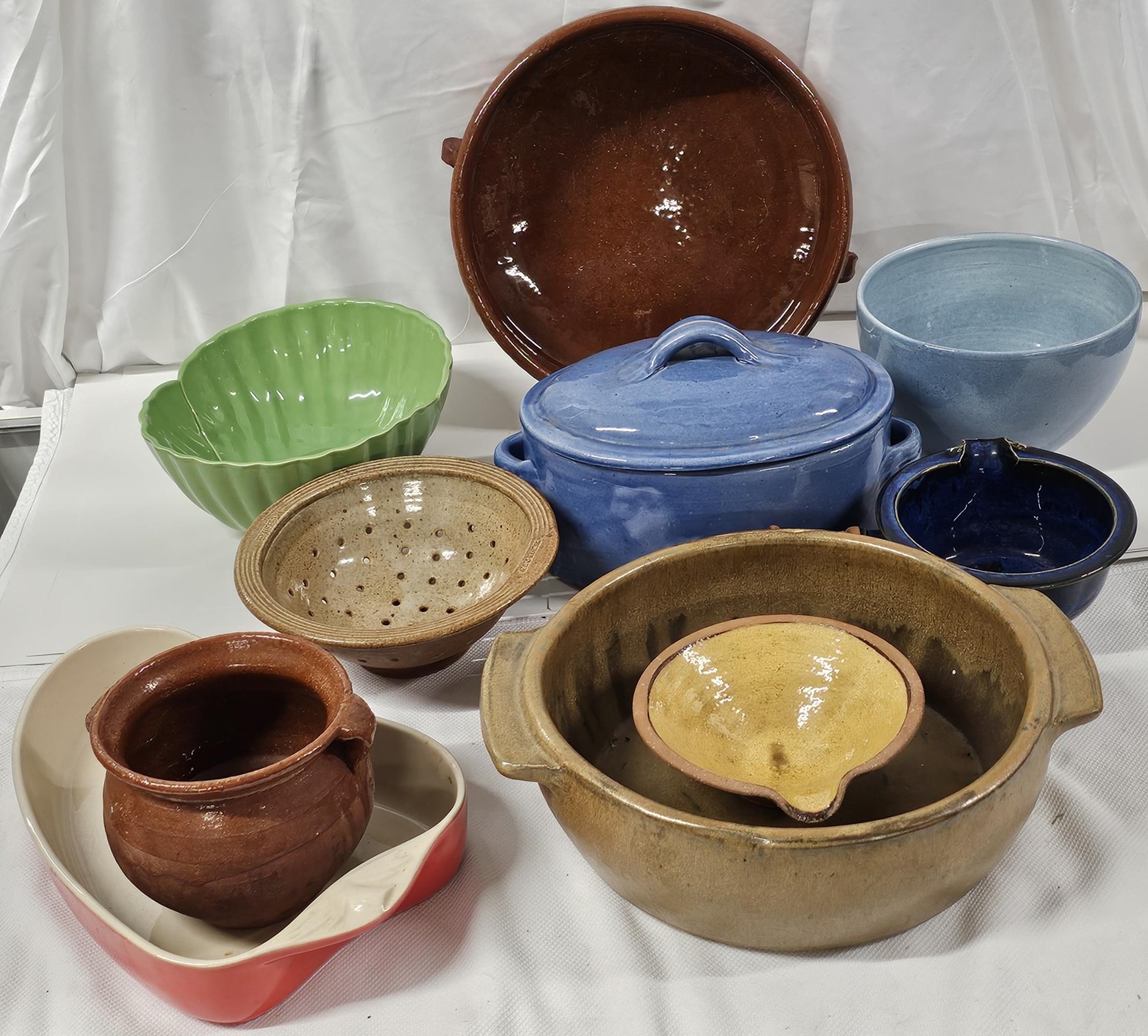 A collection of vintage kitchenware, including ceramic mixing bowls, serving dishes and casseroles.