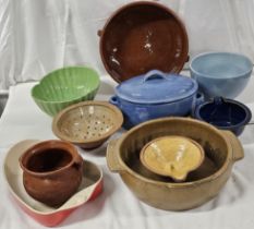 A collection of vintage kitchenware, including ceramic mixing bowls, serving dishes and casseroles.
