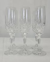 A set of six hand cut crystal champagne flutes with stylised floral design. H.22cm