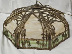 An Art Deco Miller style bronze overlay slag glass ceiling light with palm tree and mountain