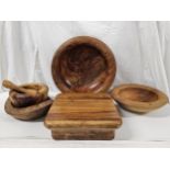 A collection of late 20th century treen, including fruit bowls, pestle and mortar, chopping board