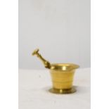An early 20th century brass pestle and mortar. Pestle is 16cm long, mortar is H.8 W.10 D.10cm.