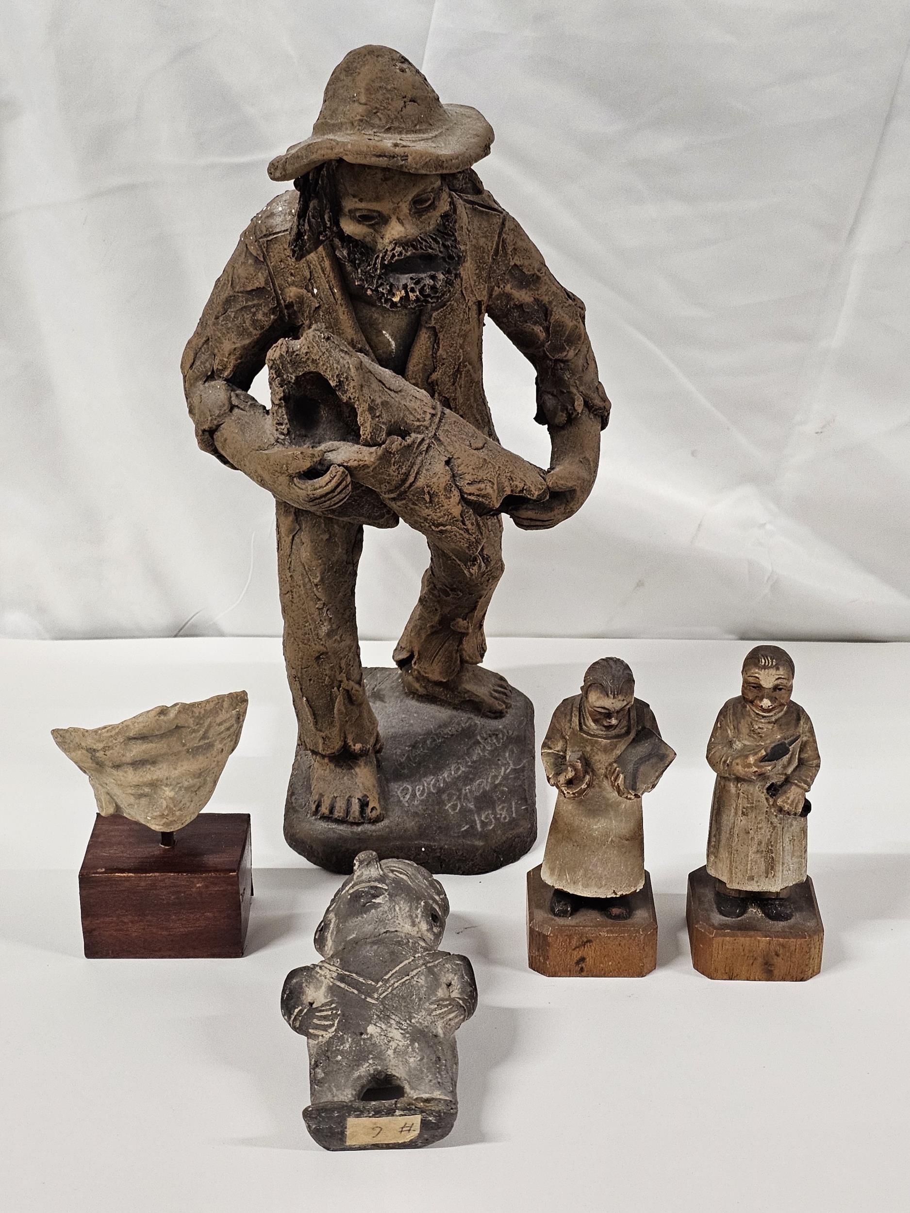 A collection of Columbian and Brazilian figures, including an art pottery figure of an old man,