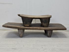 A 19th century African hardwood low stool along with a head rest. Possibly Senufo. Largest is W.