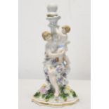 A 19th century Meissen style hand painted porcelain mother and child figural candle stick with