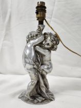 An early 20th century chrome putti form table lamp, two cherubs embracing. H.29 W.12 D.12cm.