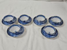 A collection of blue and white 18th century transferware white willow pattern tea bowls and saucers.