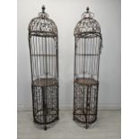 A pair of full height wrought metal Victorian style garden stands with open space above base