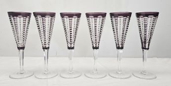 A set of William Yeoward 'Lulu' purple cut to clear glass champagne flutes. H.22cm.