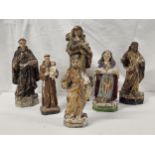 A collection of 17th/18th and 19th century carved and painted religious figures, some with gilt