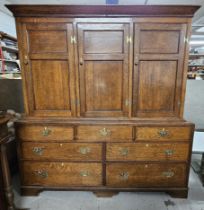 An 18th century Lancashire housekeepers cabinet with panel doors to the upper section enclosing