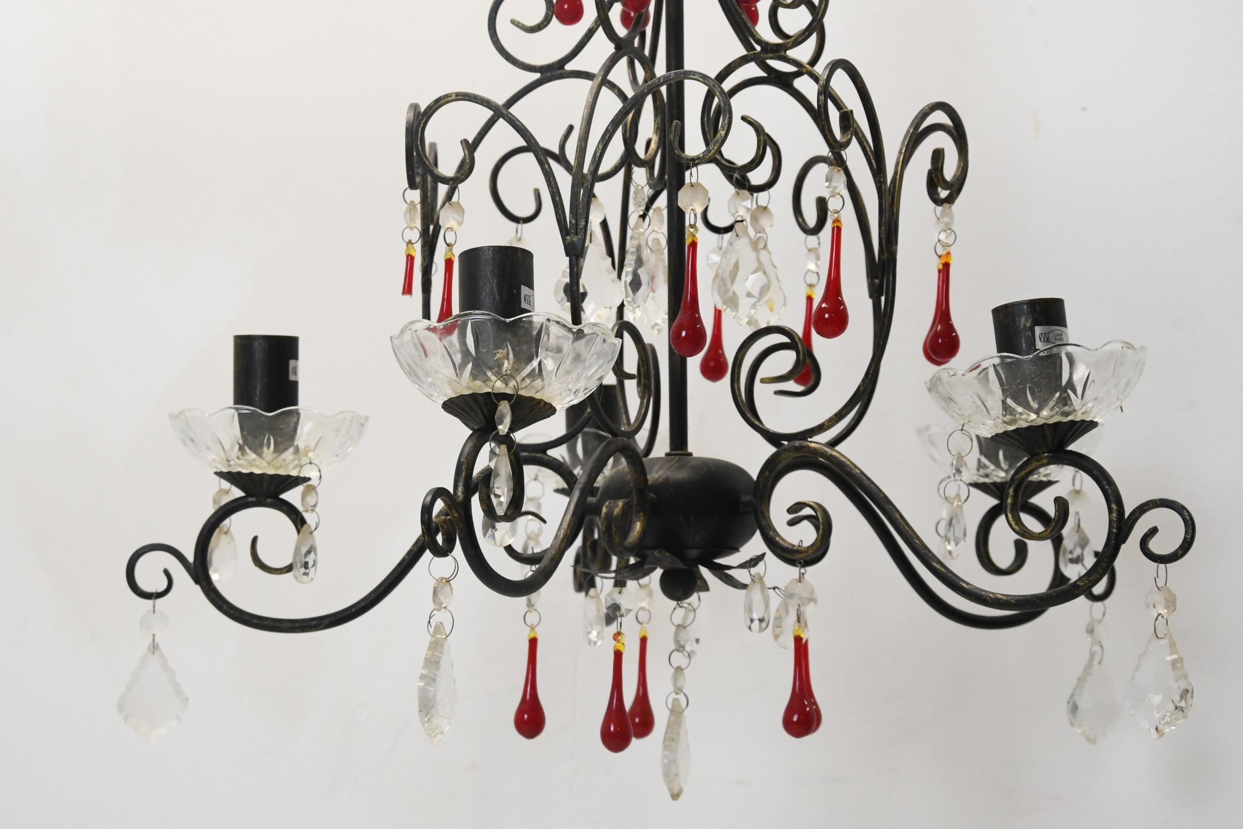 A wrought iron chandelier with five scrolling branches and ruby and cut crystal drops. H.70 W.45cm. - Image 2 of 2