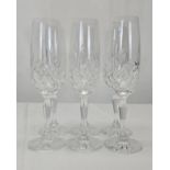 A set of six hand cut crystal champagne flutes with stylised floral design. H.22cm