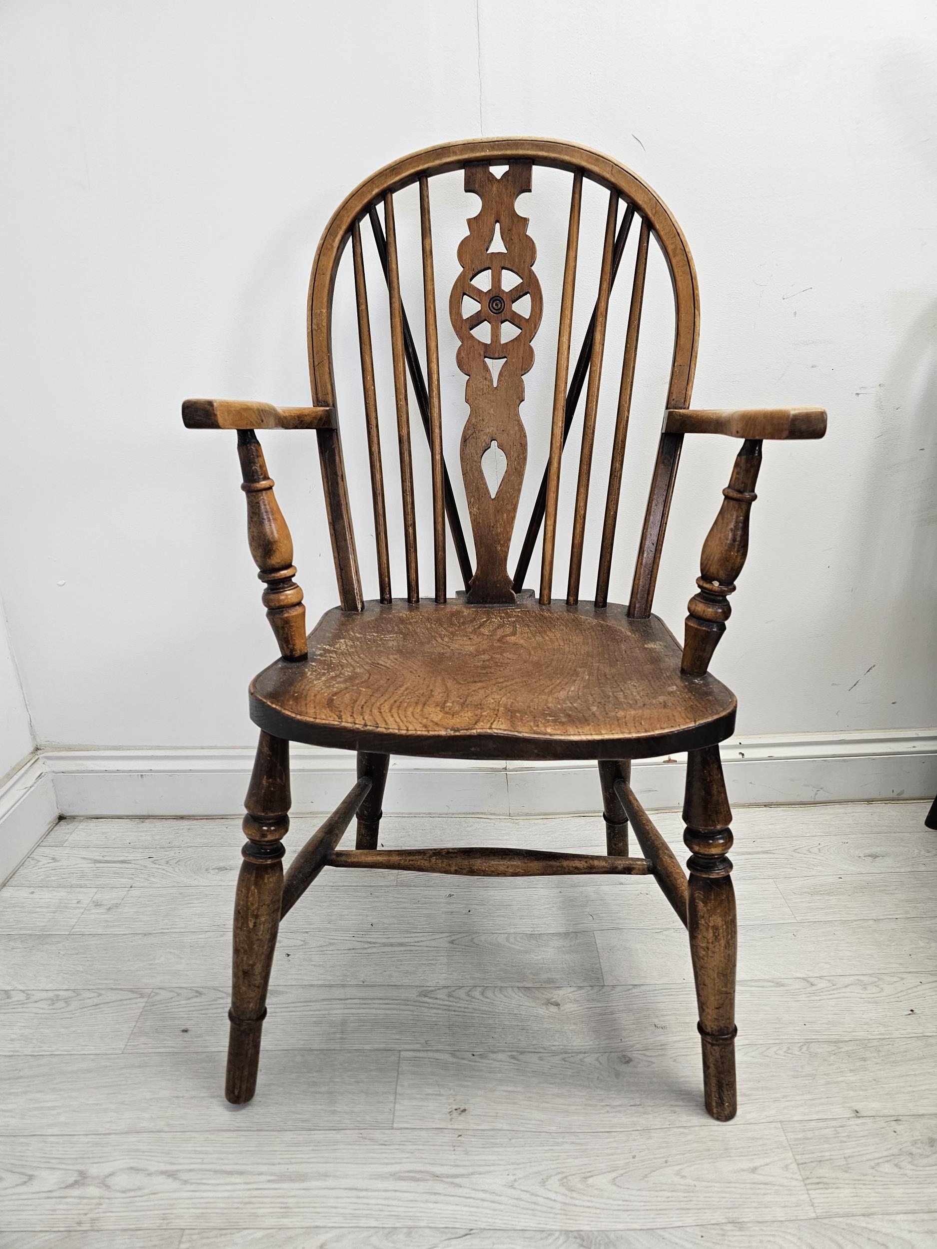 A set of six 19th century Windsor wheelback chairs to include two carver armchairs. (One chair is - Image 2 of 6