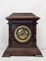 A late 19th century oak cased Ansonia mantel clock. H.38 W.35cm.