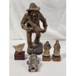 A collection of Columbian and Brazilian figures, including an art pottery figure of an old man,