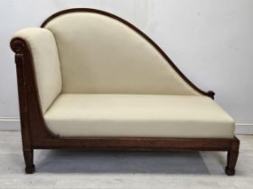 An early 19th century Continental mahogany chaise longue, reupholstered and raised on reeded