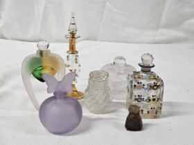 A collection of perfume bottles, including a hand painted 19th century scent bottle, a frosted mauve