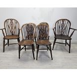 A set of six 19th century Windsor wheelback chairs to include two carver armchairs. (One chair is