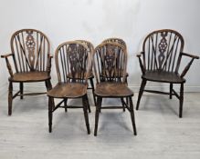 A set of six 19th century Windsor wheelback chairs to include two carver armchairs. (One chair is