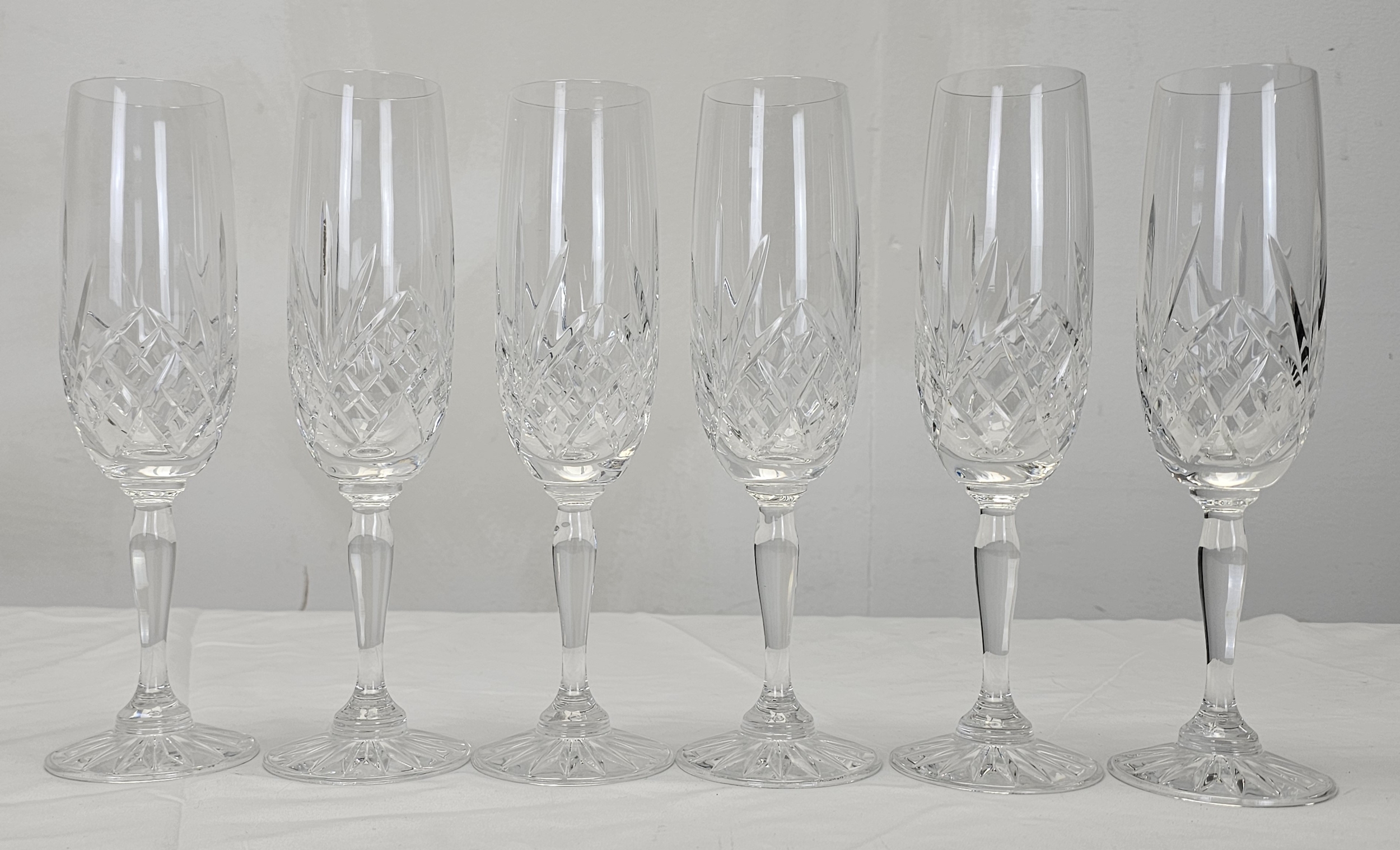 A set of six hand cut crystal champagne flutes with stylised floral design. H.22cm - Image 3 of 5