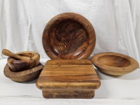 A collection of late 20th century treen, including fruit bowls, pestle and mortar, chopping board