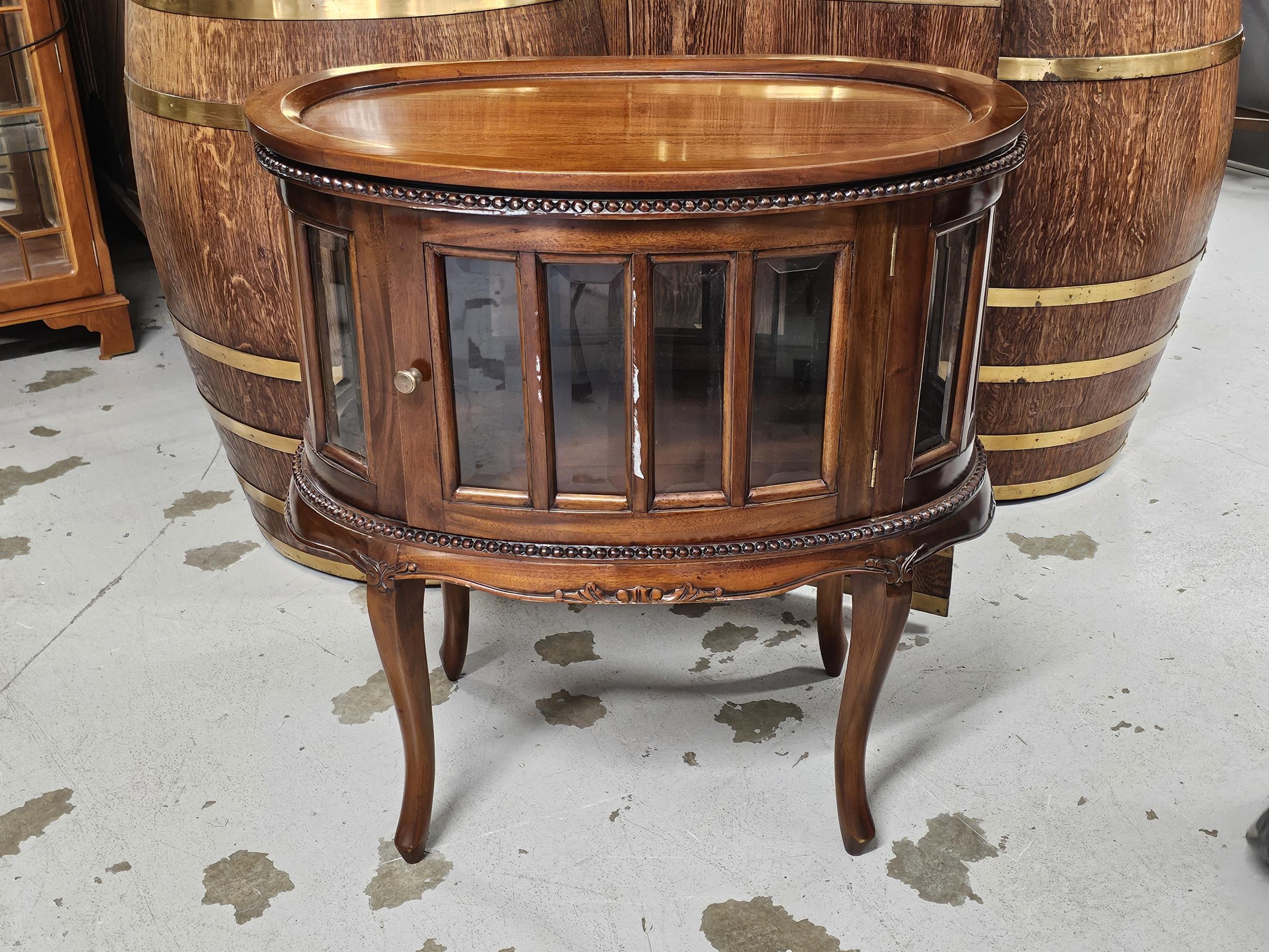 A 19th century style teak drinks or display cabinet fitted with a removable tray top. H.77 W.73cm.