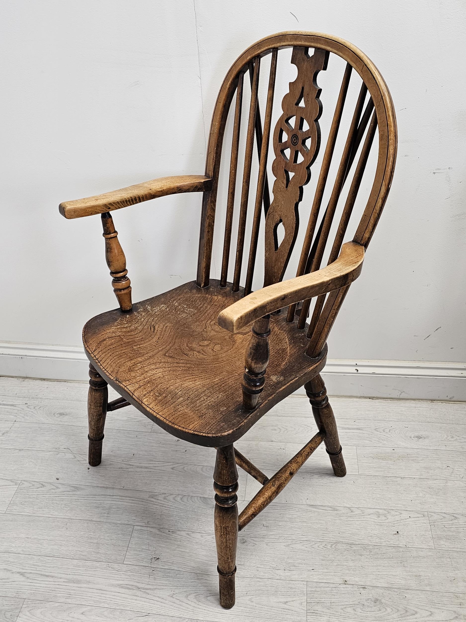 A set of six 19th century Windsor wheelback chairs to include two carver armchairs. (One chair is - Image 3 of 6