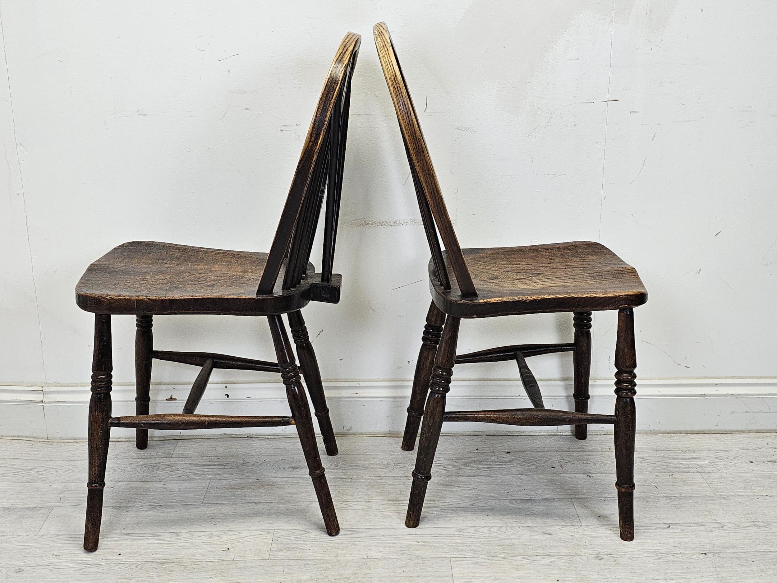 A set of six 19th century Windsor wheelback chairs to include two carver armchairs. (One chair is - Image 5 of 6