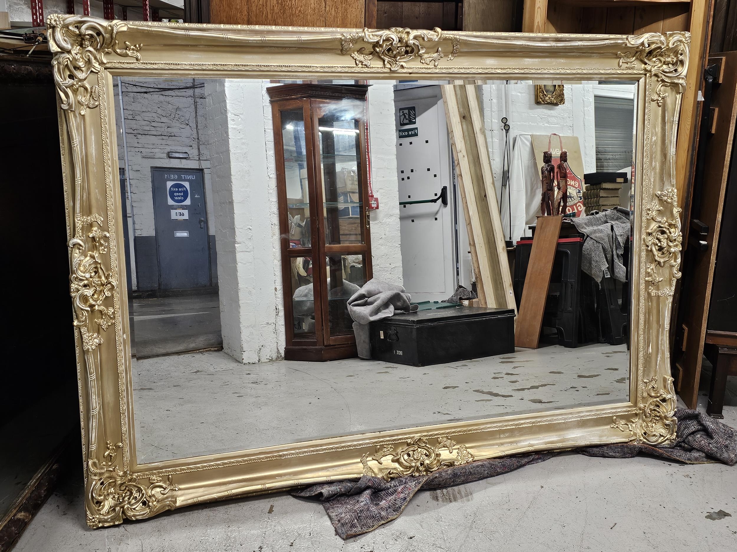 Wall mirror, large, contemporary distressed gilt frame with bevelled plate. H.213 W.150cm.