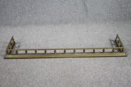 A Victorian brass fender. L.138cm. D.35cm.