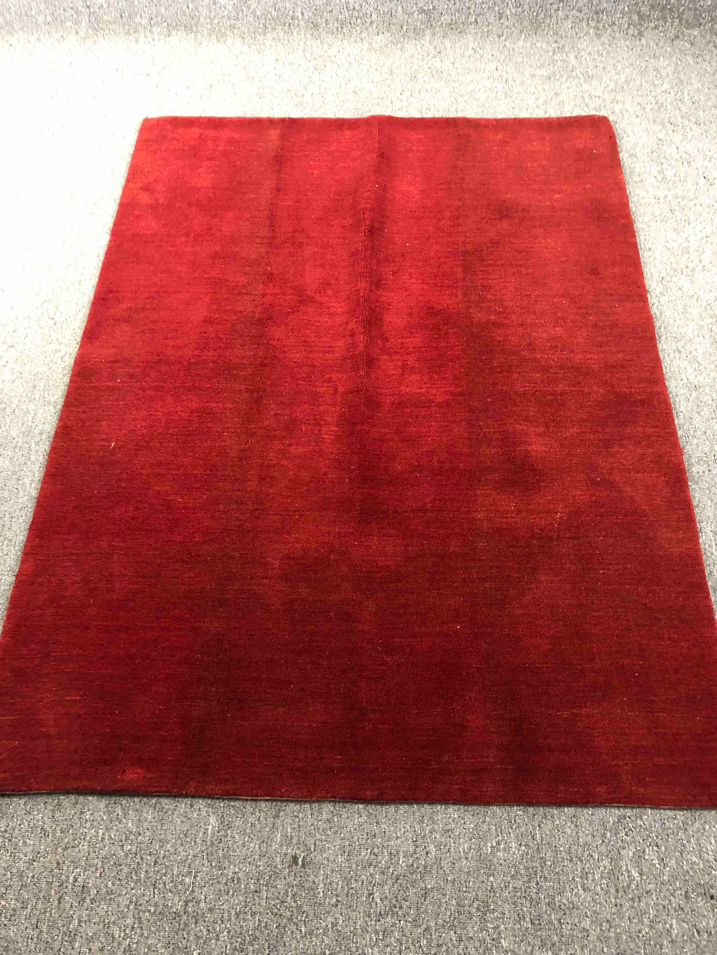 A contemporary hand knotted woollen rug. L.182 W.135cm.