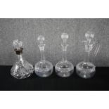 A collection of four twentieth century decanters with their stoppers. Cut glass with etched