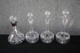 A collection of four twentieth century decanters with their stoppers. Cut glass with etched