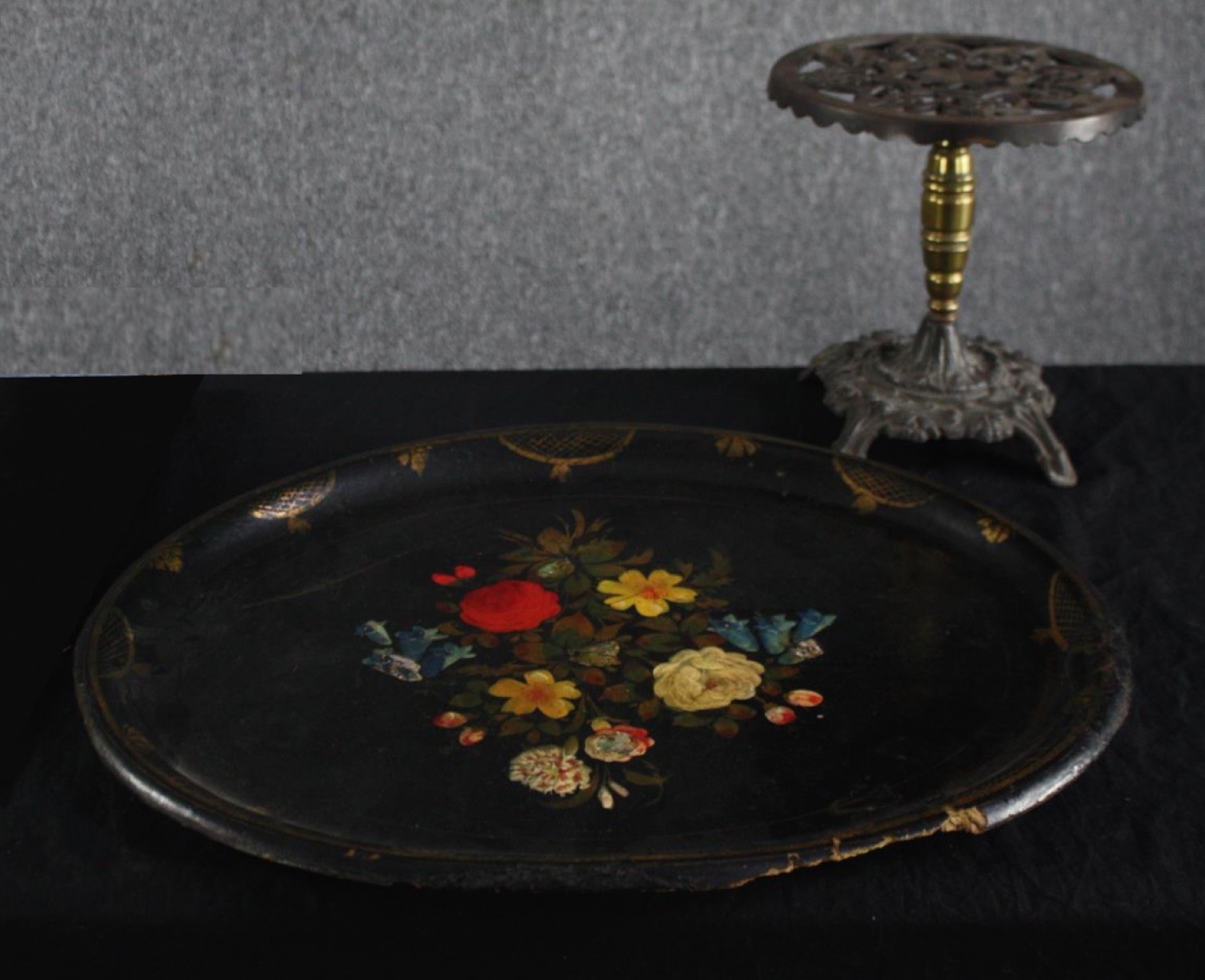 A twentieth century lacquered paper mache tray with floral decoration supported by an iron stand. - Image 2 of 6