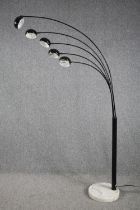 A modern floor lamp with five arms of lights and a marble base. H.198cm.