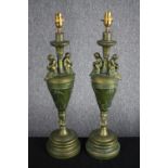 A pair of painted wooden urn design lamps. Decorated with cherubs and a worn greenish gold finish.