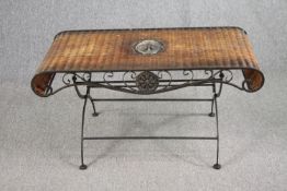 A French conservatory or coffee table, wicker on a scrolling metal frame. H.51 W.103 D.50cm.